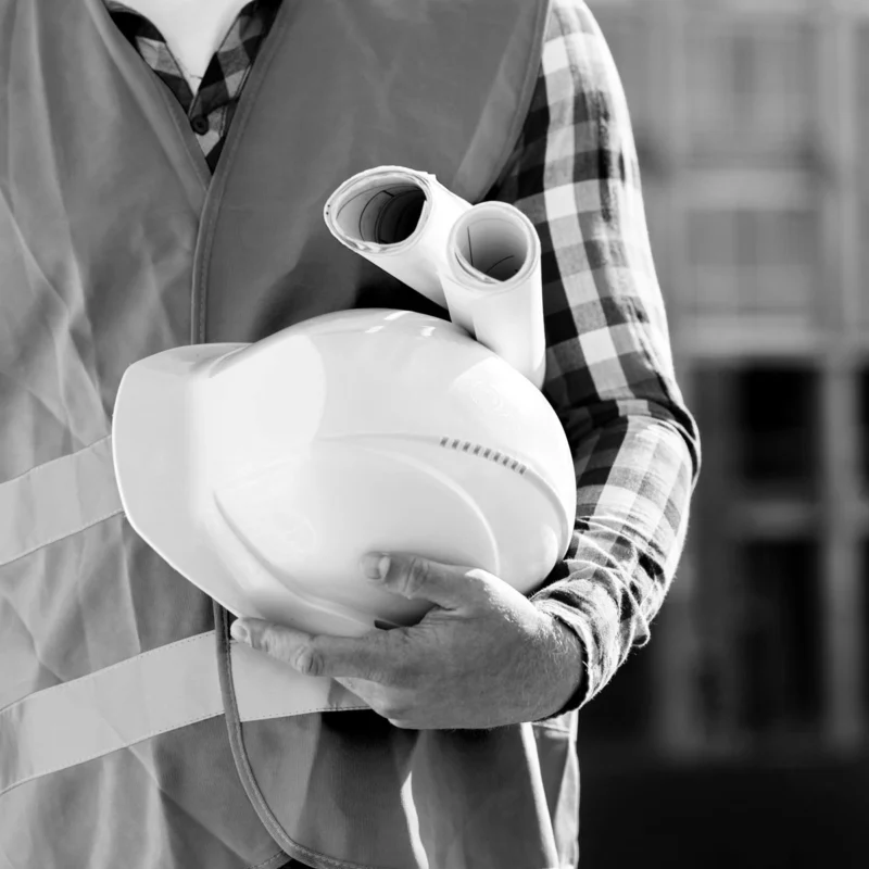 Hygienist with air monitoring equipment and respirator