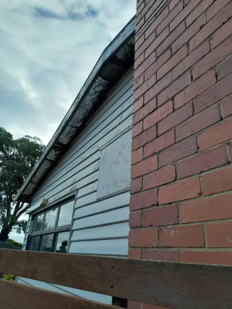 Weatherboard house with asbestos eave lining removed