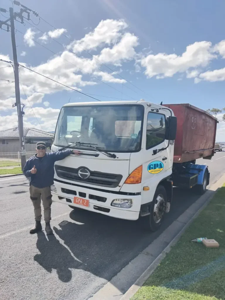 GPA team member with the GPA truck and a hook-lift waste bin